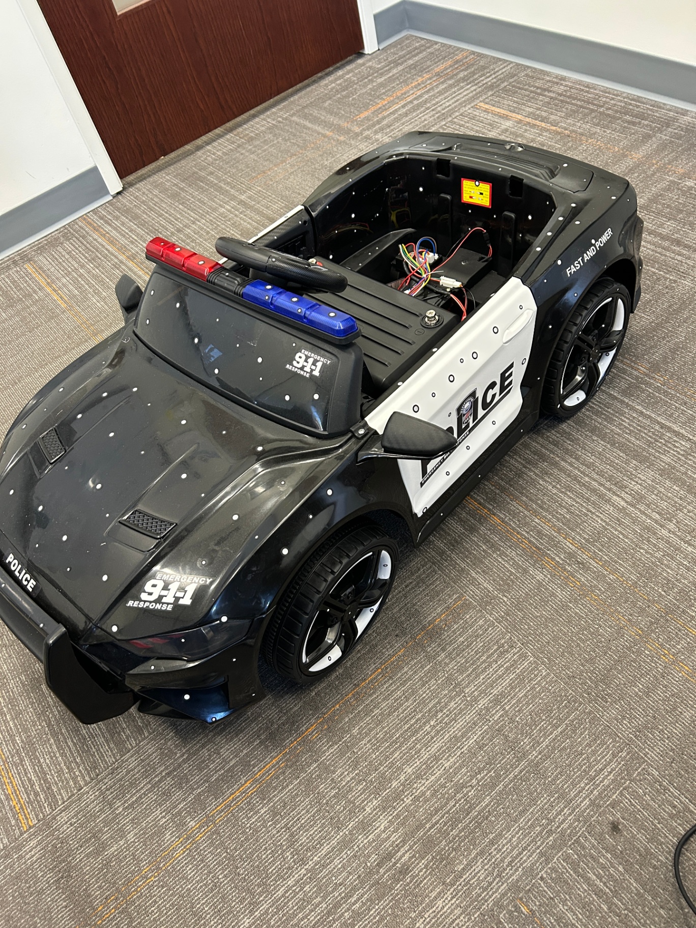 The prototype platform — a modified ride-on vehicle used for sensor integration and compute packaging development before deployment to production cruisers